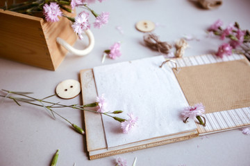 Vintage background, hand made. Old scissors, ribbons, wooden buttons, a notebook for text and flowers.