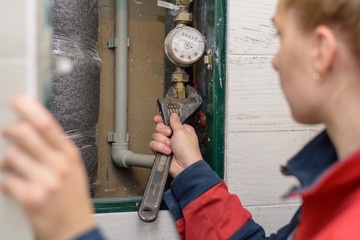Hands of plumber using wrenches while repairing pipes, close up view. plumber worker with spanner...