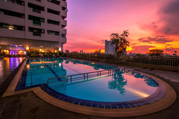 Evening light from the light. Overlooking the swimming pool and city view. 9 and traffic on the expressway, Din Daeng, Thailand