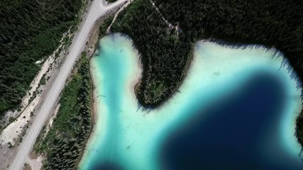 Aerial Upward Pan: Road Beside Lake and Forest - Powered by Adobe