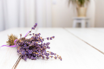 Frontal view of a lavender lying on the table with flower in the background