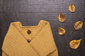 Crocheted yellow cardigan on a black background
