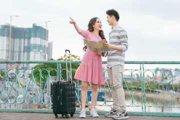 Happy asian couple on vacation sightseeing city with map © makistock
