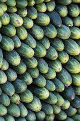 background, cucumbers lie flat on each other