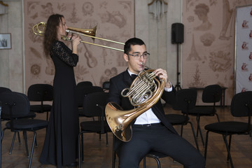 Two musicians playing on wind instruments