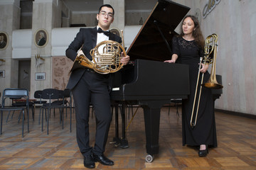 Two musicians playing on wind instruments