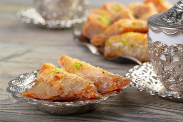Turkish sweets baklava and metal oriental tray on wooden background
