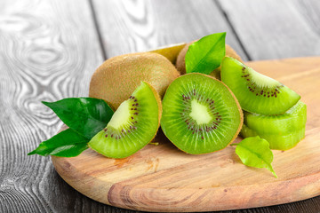 Juicy kiwi fruit on wooden table