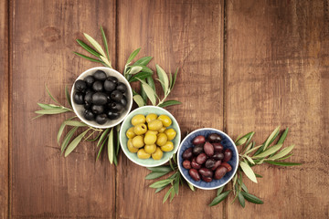 A top shot of various olives in bowls with a place for text