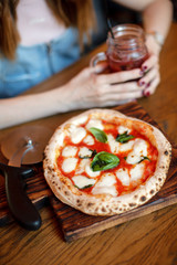 Neapolitan pizza lying on a board in a restaurant