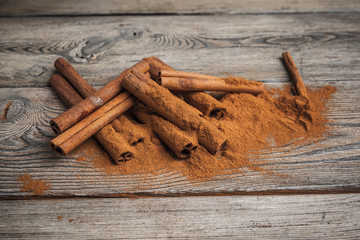 Cinnamon sticks on wooden background.