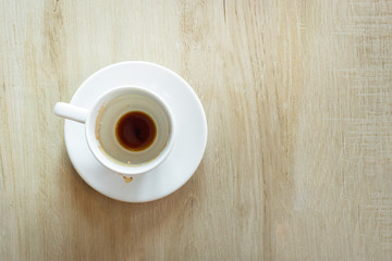 Empty coffee cup with traces of drink top view on the table.
