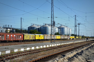 Fototapeta na wymiar Railway tracks,old wagons and silos