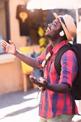 African man tourist with backpack smile  in travel place.