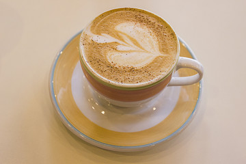 Coffee cup with milk and heart shape