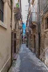 Narrow street Ortigia. Small island which is the historical centre of the city of Syracuse, Sicily. Italy.