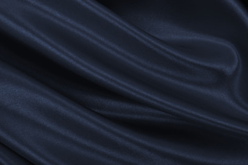 Smooth elegant dark grey silk or satin texture as abstract background. Luxurious background design