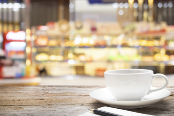 Wooden table with blur background of coffee shop.
