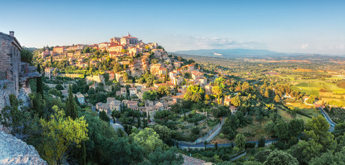 French medieval town in Provence - Gordes. Beautiful panoramic view on medieval town Gordes in sunset light. - obrazy, fototapety, plakaty