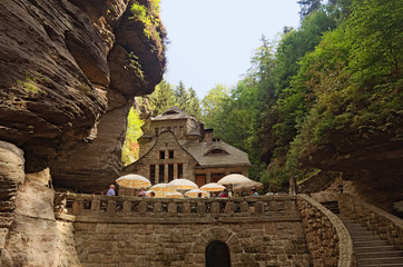 Hrensko, Czech Republic-AUGUST 23, 2018: Medieval building between the rocks in the forest. Bohemian Switzerland national park. Hrensko village is a small village on the border with Germany