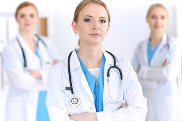 Fototapeta premium Group of medical doctors standing at hospital. Team of physicians ready to help patients. Medicine and health care concept