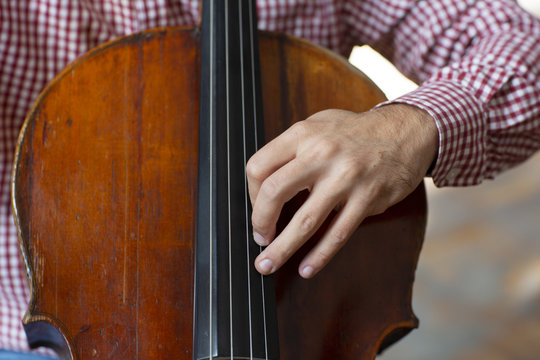 Cello playing cellist hands close up orchestra instruments