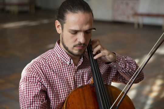 Cello playing cellist hands close up orchestra instruments
