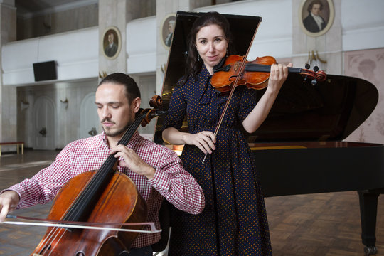 Two violinists performing together hands close up