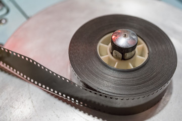 Vintage film reel or tape on a roller.