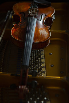 violin in vintage style on wood background close up