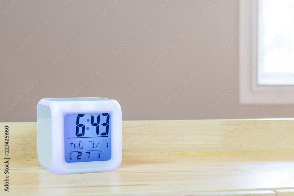 Aufkleber led alarm clock standing on table background. digital timer display. copyspace for your design.