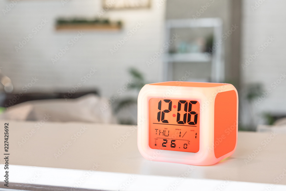 Aufkleber led alarm clock standing on table background. digital timer display. copyspace for your design.