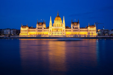 Fototapeta na wymiar travel and european tourism concept. Budapest, Hungary. Hungarian Parliament Building over Danube River illuminated at night.