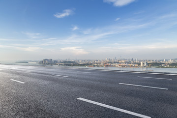 Fototapeta premium Panoramic skyline and modern business office buildings with empty road,empty concrete square floor