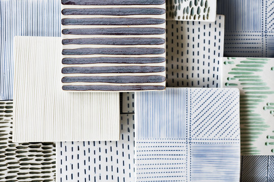 Variety of handmade decorative clay tiles with different patterns and colors. Craft, art, design background. Text space