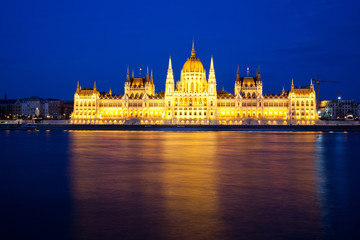 travel and european tourism concept. Budapest, Hungary. Hungarian Parliament Building over Danube River illuminated at night.