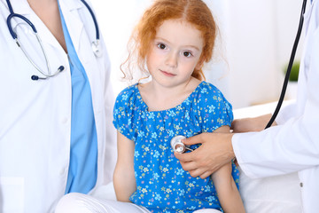 Doctor examining a little girl with stethoscope.Medicine and healthcare concept