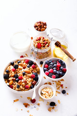 Granola Cereal bar with Strawberries blueberries and Milk on light Background . Muesli Breakfast. Healthy Food sweet dessert snack. Diet Nutrition Concept. Vegetarian food. Copy space