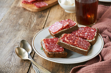 Sandwiches with butter and salami on a plate  