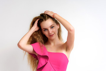 Fototapeta premium Studio portrait of a beautiful girl blonde teenager on a white background.