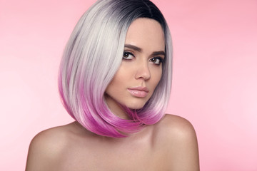 Ombre bob short hairstyle. Beautiful hair coloring woman. Trendy puprle haircut. Blond model with short shiny haircuts isolated on pink Background. Makeup. Beauty Salon.