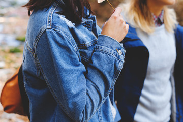 Blue denim jacket and parka. Clothing for the camping trip. Hiking clothes. Two young girls friends walking in the autumn forest. Walk in the woods at fall. © NesolenayaAleksandra