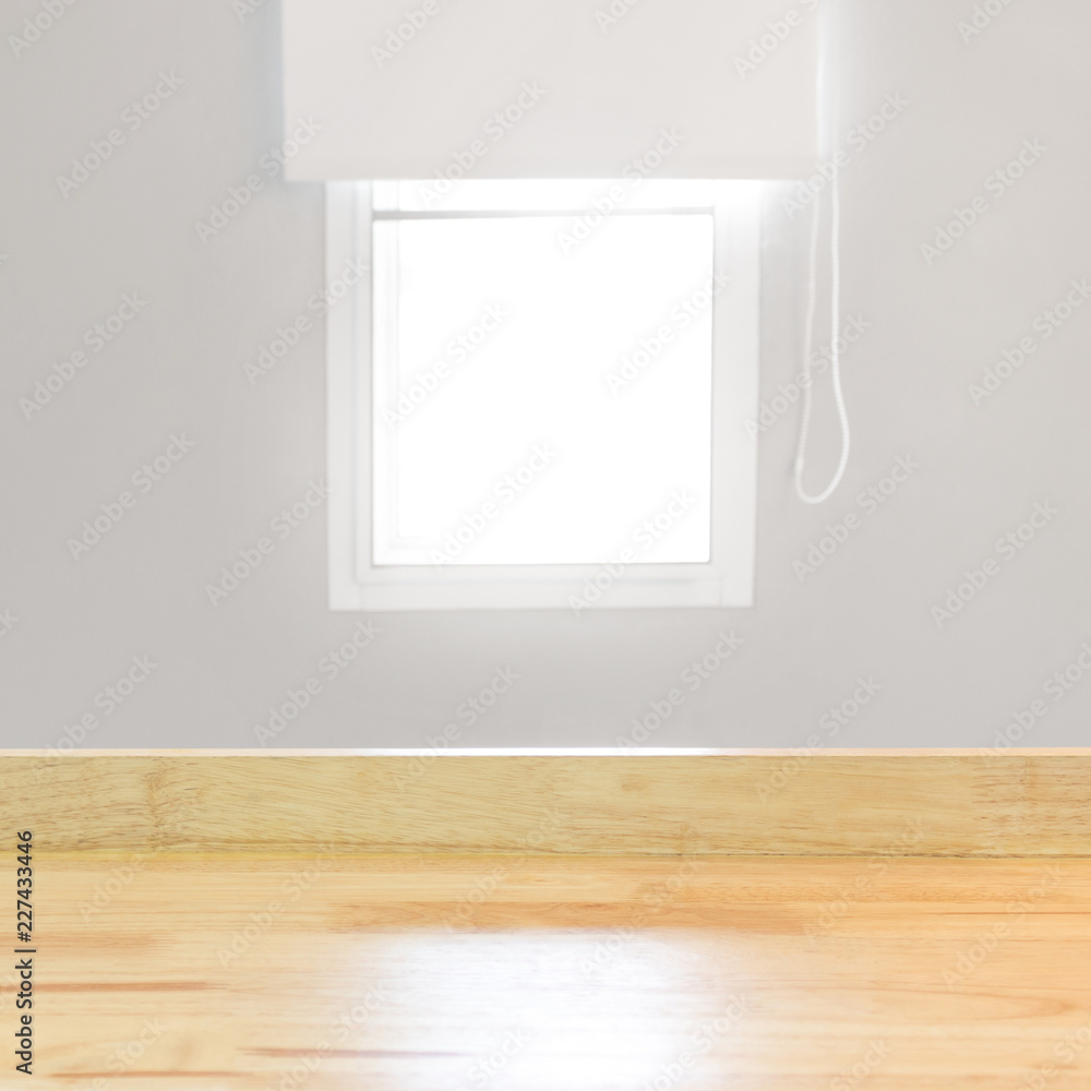 Aufkleber blank wood table top view and blur window on grey wall from office with sunlight. modern room for pr