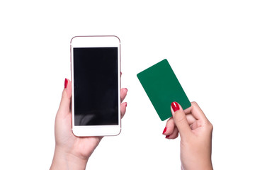 Female hands holding phone and credit card on isolated background