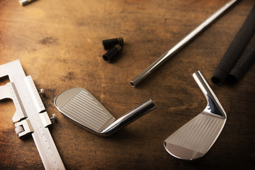 Assembling golf clubs or golf club making. Iron head, steel shaft, ferrule and grip on a well used...