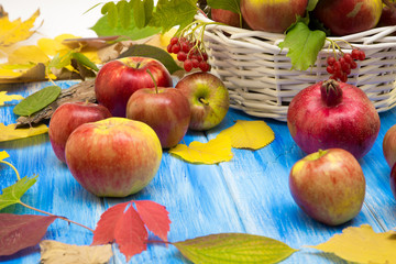 Autumn bright background. Flowers, leaves and fruits on a blue wooden background. Background for the autumn holidays and thanksgiving day.