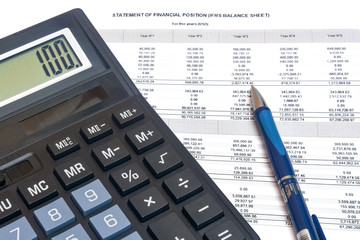 accountant calculator with report and pen