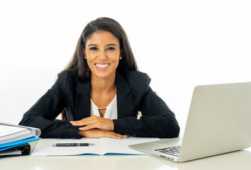 Portrait of attractive young businesswoman working on her laptop looking happy and confident