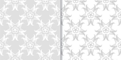 Light gray floral ornamental designs. Set of seamless patterns