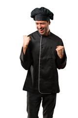 Chef man In black uniform celebrating a victory and happy for having won a prize on isolated white background